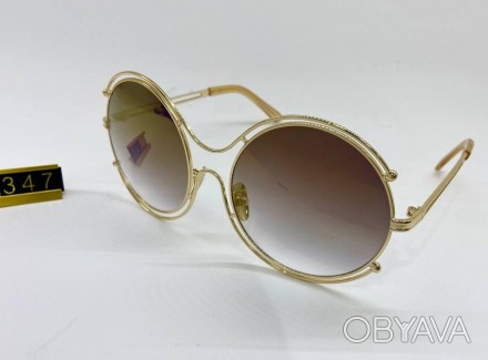 солнцезащитные женские очки круглые в тонкой золотистой оправе с коричневыми лин. . фото 1