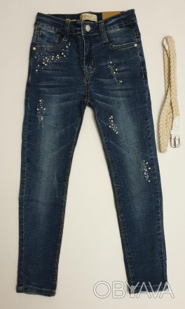 Синие стрейчевые джинсы для девочки
Украшены бусинками и стразами (на заклепках,. . фото 1