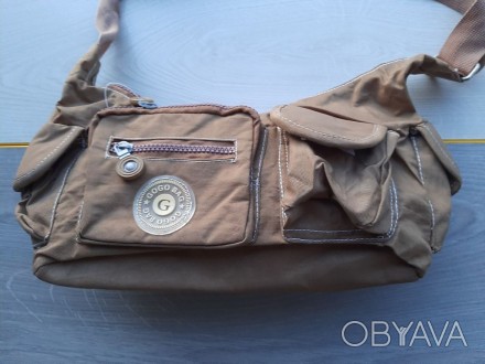 Женская сумка из плащевой ткани (уценка)

Практичная ткань
Впереди два карман. . фото 1