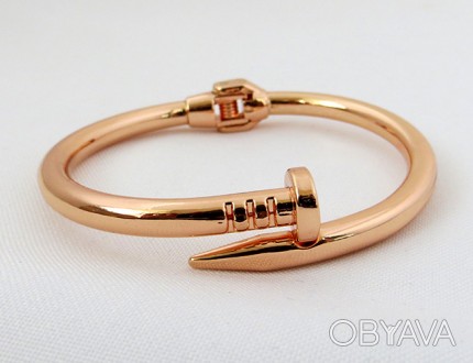 Модный браслет в форме согнутого гвоздя. Цвет метала золотистый с розовым оттенк. . фото 1